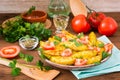 Baked potatoes in a peel with tomatoes in a plate Royalty Free Stock Photo