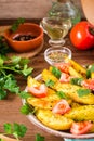 Baked potatoes in a peel with tomatoes in a plate. Vegetables, h Royalty Free Stock Photo