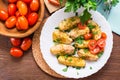 Baked potatoes with ripe tomatoes and fresh herbs on a plate Royalty Free Stock Photo