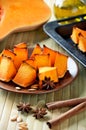 baked pumpkin, cinnamon sticks, star anise and olive oil on a kitchen table vertical closeup Royalty Free Stock Photo