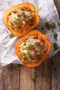 Baked pumpkin with couscous, meat, vegetables and cheese close-up