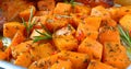 Baked pumpkin pieces with spices and herbs. Diet menu. Vegetarian dish. Close-up Royalty Free Stock Photo