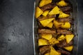 baked pumpkin with pork ribs in a glass form on a black table, top view of a cooked pumpkin with meat, copy space Royalty Free Stock Photo