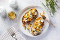 Baked pumpkin sandwich with dorblu cheese with blue mold, honey and thyme on a concrete old light background.