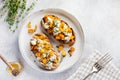 Baked pumpkin sandwich with dorblu cheese with blue mold, honey and thyme on a concrete old light background.