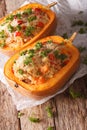 Baked pumpkin stuffed with couscous, meat and cheese close-up.