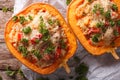 Baked pumpkin stuffed with couscous, meat and vegetables close-up