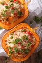 Baked pumpkin stuffed with couscous, meat and vegetables close-up