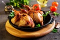 Baked quails in pan on a dark background Royalty Free Stock Photo