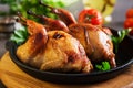 Baked quails in pan on a dark background Royalty Free Stock Photo