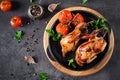 Baked quails in pan on a dark background. Royalty Free Stock Photo