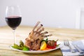 Baked rack of lamb with glass of red wine Royalty Free Stock Photo