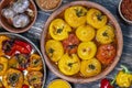 Baked red and yellow tomato and bell pepper. Tomatoes and bell peppers in a baking dish on a wooden table. A healthy and delicious Royalty Free Stock Photo