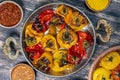 Baked red and yellow tomato and bell pepper. Tomatoes and bell peppers in a baking dish on a wooden table. A healthy and delicious Royalty Free Stock Photo