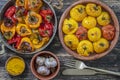 Baked red and yellow tomato and bell pepper. Tomatoes and bell peppers in a baking dish on a wooden table. A healthy and delicious Royalty Free Stock Photo