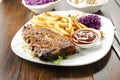 Baked ribs and French fries and cabbage salad