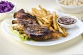 Baked ribs and French fries and cabbage salad Royalty Free Stock Photo