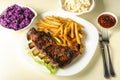 Baked ribs and French fries and cabbage salad Royalty Free Stock Photo