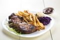 Baked ribs and French fries and cabbage salad Royalty Free Stock Photo