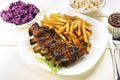 Baked ribs and French fries and cabbage salad Royalty Free Stock Photo