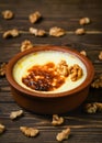 Baked rice pudding - turkish milk dessert sutlac in earthenware casserole with walnuts. Turkish Cuisine dessert varieties. Close