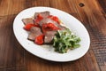 Baked roast beef with rucola and red bell pepper