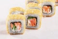 Baked roll sushi, smoked salmon, tuna, lettuce, cheese, close-up,
