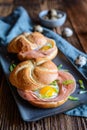 Baked rolls stuffed with ham, quail eggs and green onion