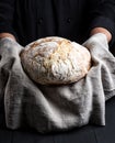 Baked round homemade bread on a gray napkin