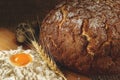 Baked ruddy bread, a row of winter wheat spikes, a hill of flour and quail eggs Royalty Free Stock Photo