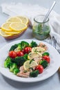 Baked salmon fillet with broccoli and tomato on plate, salmon steak with vegetables, vertical Royalty Free Stock Photo