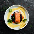 Baked salmon fillet with wild rice and vegetables. Royalty Free Stock Photo