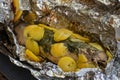 Baked salmon fish in foil. Tasty dish, cooked with potatoes and dill. Royalty Free Stock Photo