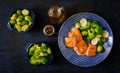 Baked salmon fish garnished with broccoli and Brussels sprouts with leek.