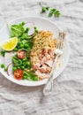 Baked salmon with lemon grain crust and fresh vegetable salad with peas, spinach, radishes and cherry tomatoes. Royalty Free Stock Photo