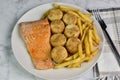 baked salmon with scallops served with a side of fries