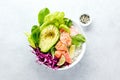 Baked salmon super bowl with avocado and fresh greens