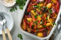 Baked sausage and vegetables, peppers, zucchini, tomatoes, red onion and eggplant with sesame and cilantro served hot from oven Royalty Free Stock Photo