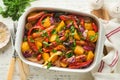 Baked sausage and vegetables, peppers, zucchini, tomatoes, red onion and eggplant with sesame and cilantro served hot from oven Royalty Free Stock Photo