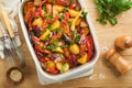 Baked sausage and vegetables, peppers, zucchini, tomatoes, red onion and eggplant with sesame and cilantro served hot from oven Royalty Free Stock Photo