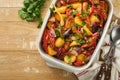 Baked sausage and vegetables, peppers, zucchini, tomatoes, red onion and eggplant with sesame and cilantro served hot from oven Royalty Free Stock Photo