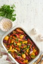Baked sausage and vegetables, peppers, zucchini, tomatoes, red onion and eggplant with sesame and cilantro served hot from oven Royalty Free Stock Photo