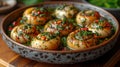 Baked scallops with spicy sauce in a bowl on the table. Eco-farm of grape snails. Delicacies and unusual dishes. Royalty Free Stock Photo