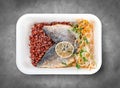 Baked sea bass with red rice. Healthy diet. Takeaway food. Eco packaging. Top view, on a gray background