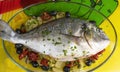 Baked sea bream with potatoes, olives and dried tomatoes. Royalty Free Stock Photo