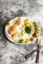 Baked sea fish fillet with vegetables. Tilapia fillet with broccoli, cherry tomatoes, fried potatoes, green peas and lettuce Royalty Free Stock Photo