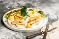 Baked sea fish fillet with vegetables. Tilapia fillet with broccoli, cherry tomatoes, fried potatoes, green peas and lettuce Royalty Free Stock Photo