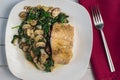 baked season salmon with a side of sauteed spinach and mushrooms