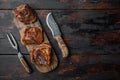 Baked short beef ribs , on old dark wooden table background, top view flat lay, with copy space for text