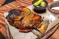 The baked shoulder of a kid, a traditional Greek dish, lies on the Board Royalty Free Stock Photo